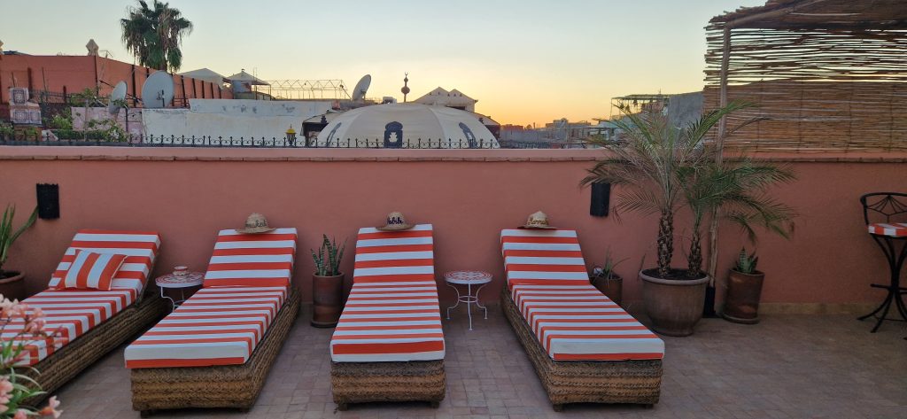 Transats sur le rooftop face aux toits de Marrakech